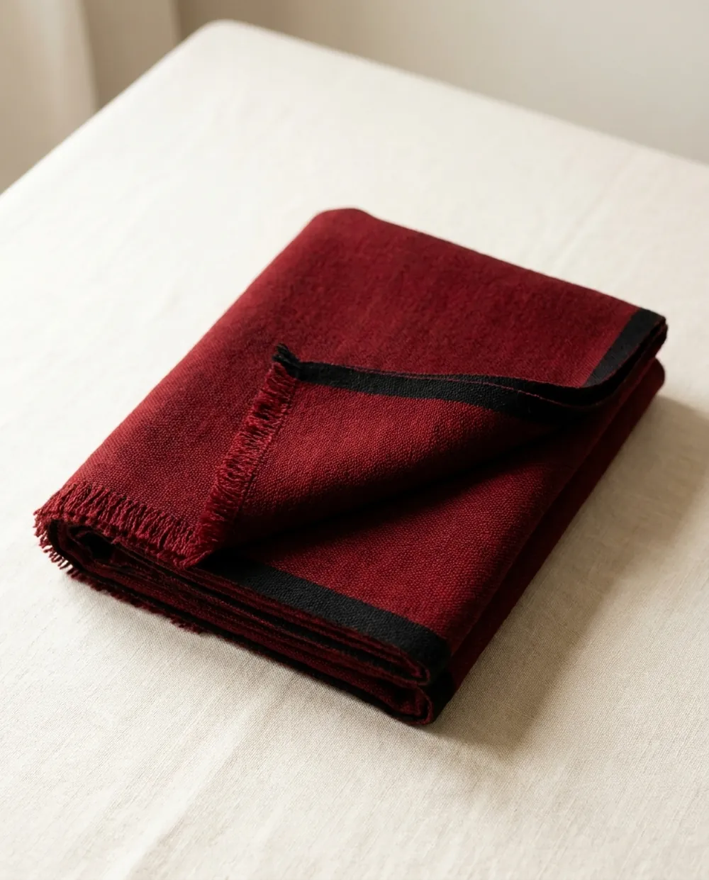 Folded plain oxblood red Maasai shuka
